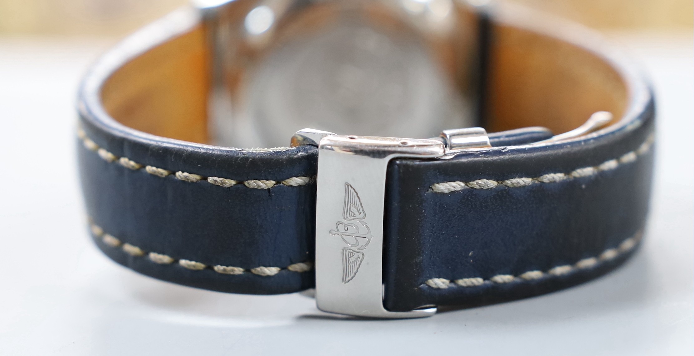 A gentleman's modern stainless steel Breitling chronograph automatic wrist watch, with blue Roman dial, on leather strap with deployment clasp, no box or papers.
